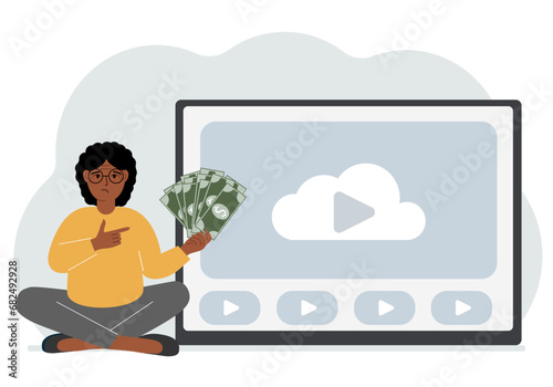 A woman holds paper banknotes in his hand, next to a computer with a video. Freelancer, earning money, working on the Internet, training, coaching, business, remote work.