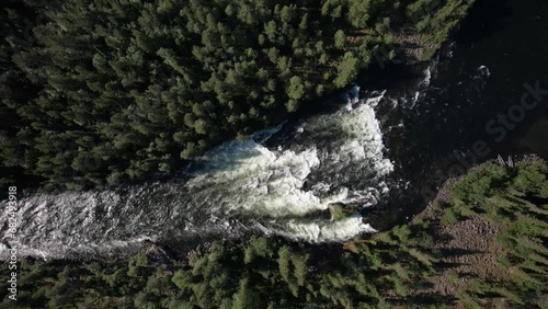 top view of the mountain river threshold turbulent water washes the island the river flows among the taiga Umba Kola peninsula waterfall High quality 4k footage photo