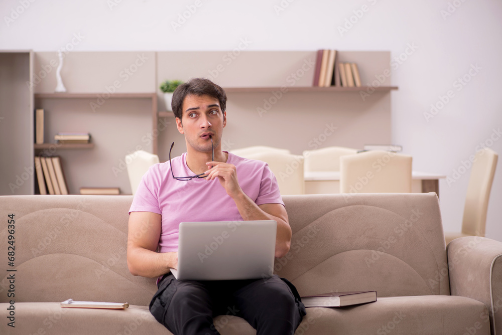 Young male student preparing for exams at home Young male student preparing for exams at home