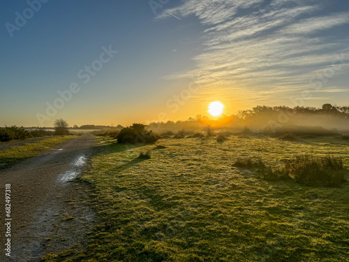 Fototapeta Naklejka Na Ścianę i Meble -  Misty Morning Sunrise at RAF Greenham Common near Newbury Berkshire