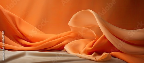 In the abstract design, the use of textured fabric like linen is evident in the simple yet visually striking orange color, as the light illuminates the cloth, creating a beautiful sheen on the sheet.