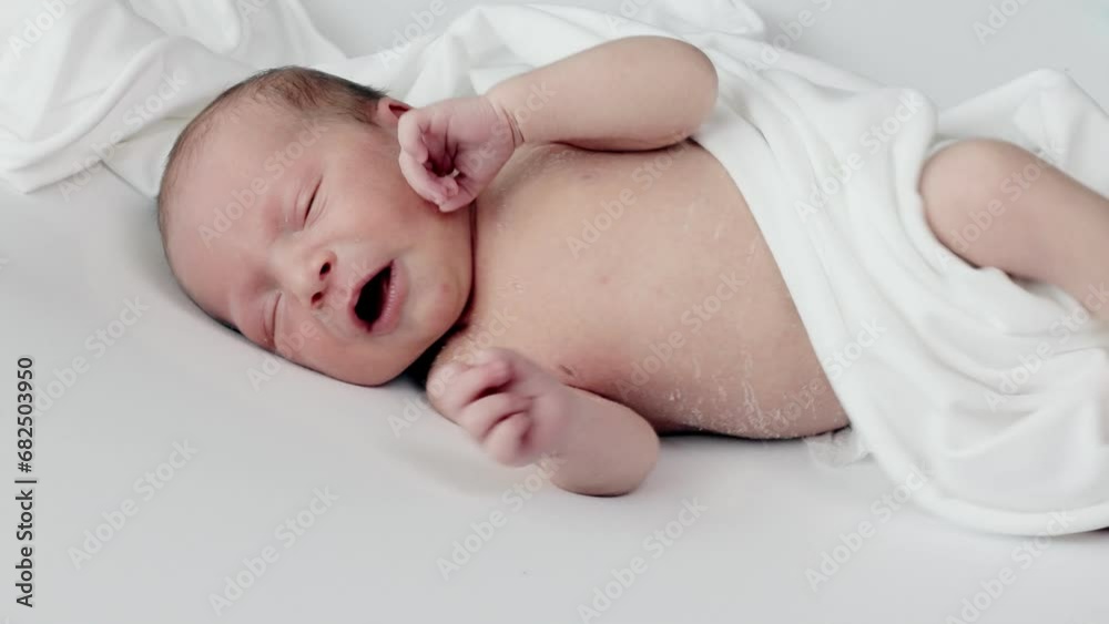 A newborn boy is crying. Newborn baby tired and hungry in bed. Children are crying. A child's cry. A healthy little baby soon after birth. A newborn boy is crying. Newborn baby tired and hungry in bed. Children are crying. A child's cry. A healthy little baby soon after birth.