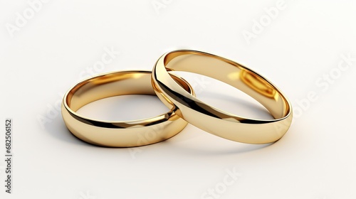 couple of gold wedding rings on white background