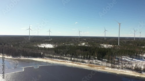 Wind turbines roatating in winter landscape photo