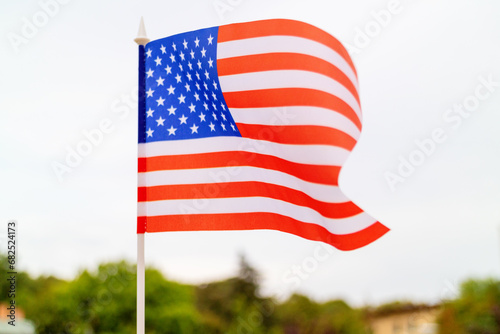 The American flag flutters in the sky. close up of USA flag  stars and stripes  United States of America.