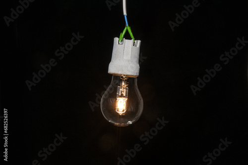 Wallpaper Mural Glowing light bulb close up on a black background Torontodigital.ca