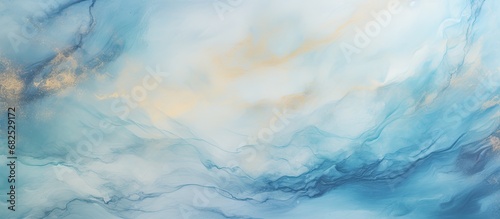 In an abstract design on the marble wall, blue watercolor textures blended with hints of gold and light depict a nature-inspired art piece, with swirling clouds and a touch of green, creating a photo
