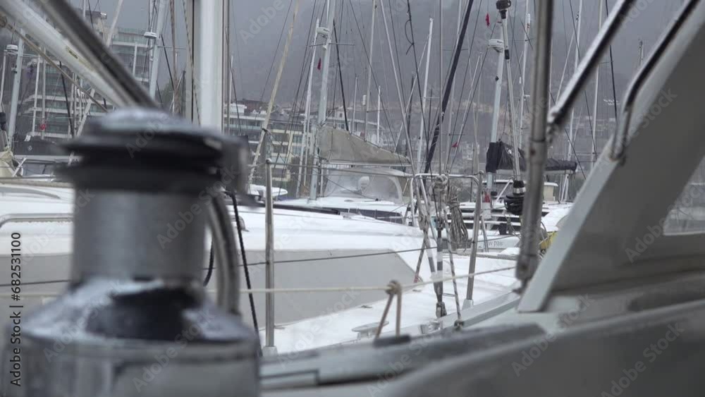 Drops of autumn rain break on the winch of a sailing yacht in the harbor.Slow motion. Drops of autumn rain break on the winch of a sailing yacht in the harbor.Slow motion.