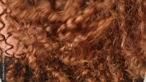 Brown brunette curly wavy hair texture close-up macro. Hairstyle. Body spa and relax ritual self and hair care photo