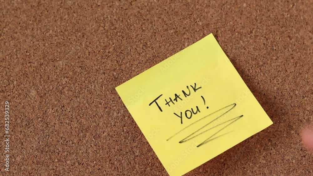 Thank you note in yellow color handwritten with black marker on cork