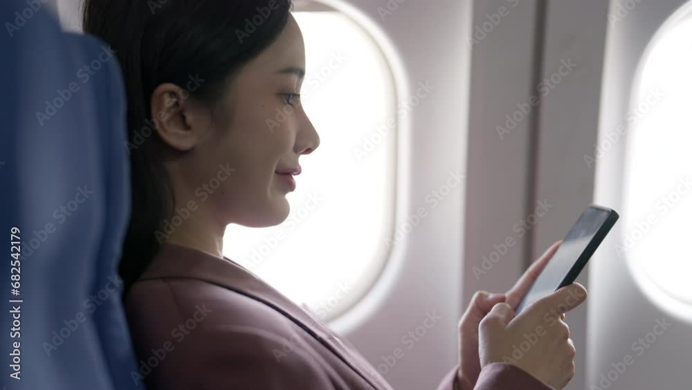 Passengers use mobile phones while on plane. Passengers use mobile phones while on plane.