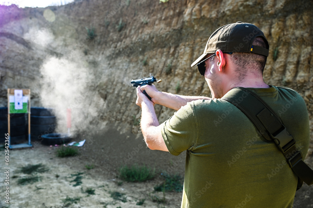 Man shoots a pistol at a target