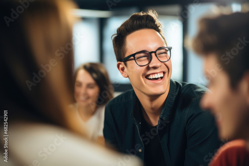 Man with glasses sitting at table, smiling. This image can be used for business, education, or lifestyle-related projects