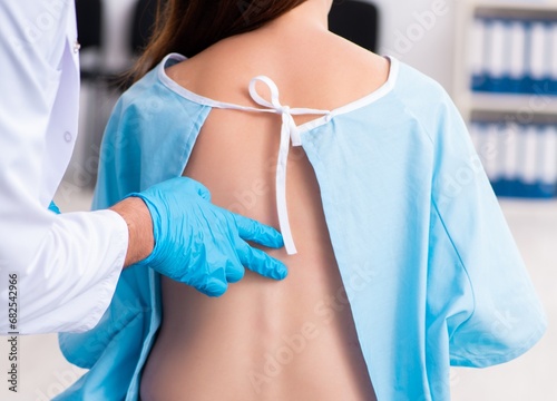 Injured young woman visiting young male doctor