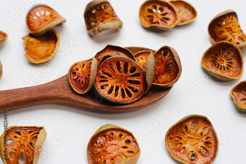 Dried bael fruit slices on white background. photo