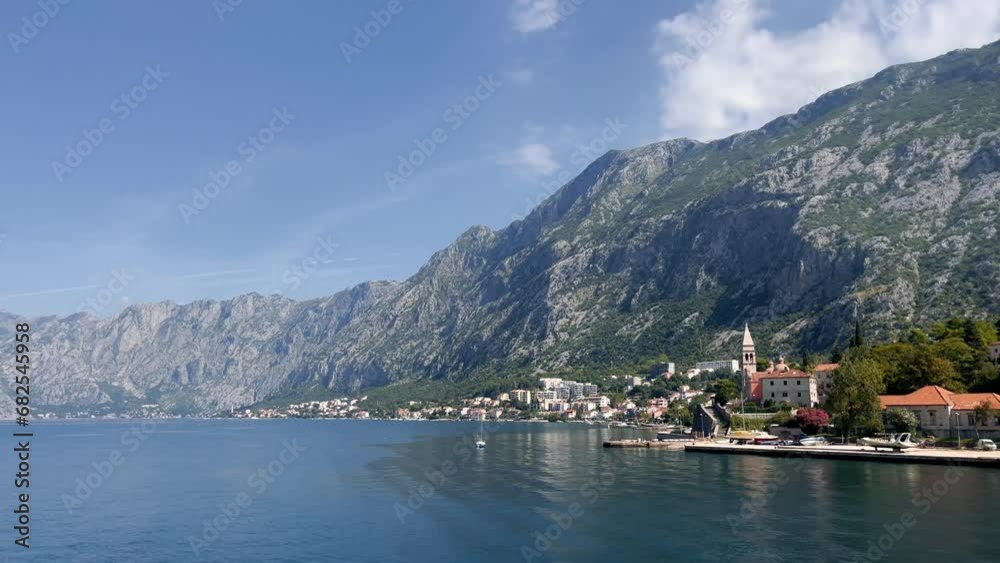 Tower St. Matthias Church in Dobrota town, Montenegro. Photo shot from a passing ship 4K. Tower St. Matthias Church in Dobrota town, Montenegro. Photo shot from a passing ship 4K.