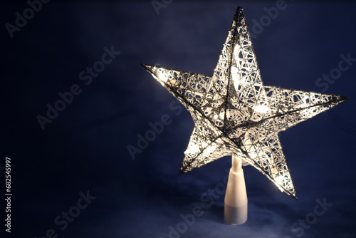 Light star in the dark. Christmas decoration.
