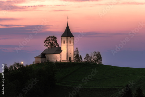 Church on a hill at dawn (St. Primož and Felicijan on Jamnik)