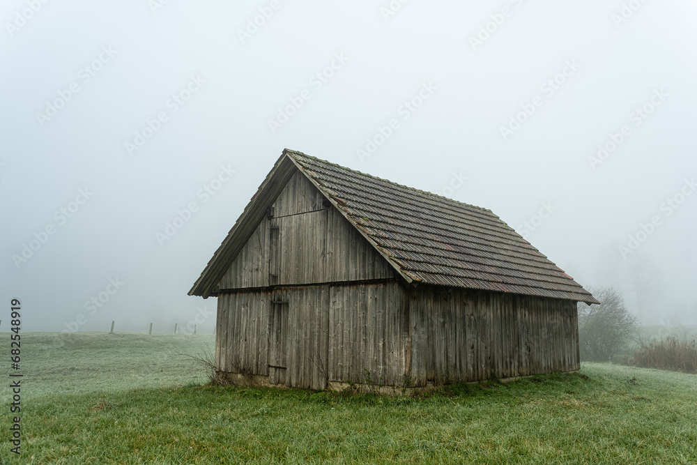Old barn in a foggy field Old barn in a foggy field