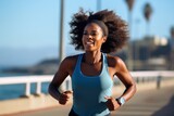 Portrait of sporty black woman runner running on city bridge road against blue background. Afro american, multi racial concept of sportive athletes..