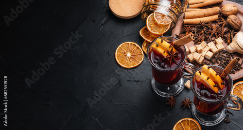 Mulled wine is the main drink of Christmas markets on a dark background. Christmas banner. photo