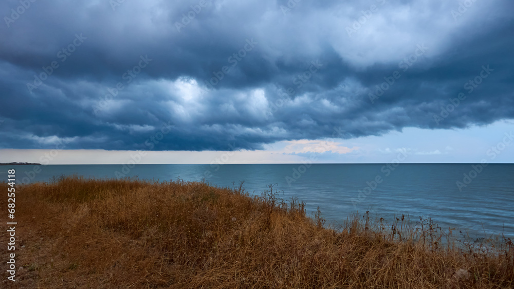 dramatic clouds float over the coast of the Sea of Azov