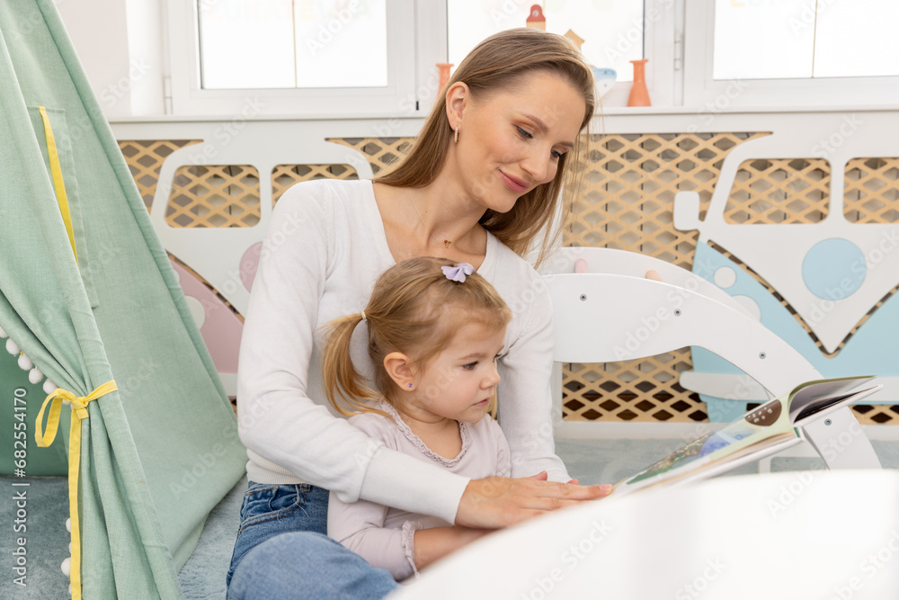 Young mother reading to her toddler child Young mother reading to her toddler child