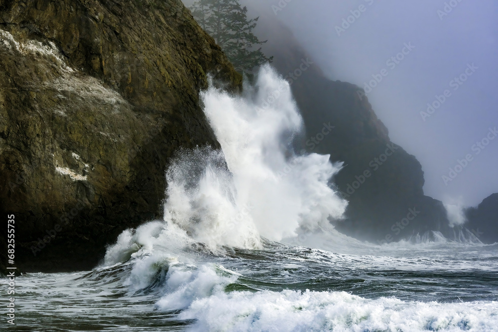 Crashing waves on the rocks at Cape Disappointment on a foggy, fall day