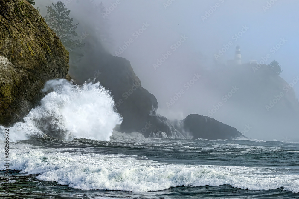 Crashing waves on the rocks at Cape Disappointment on a foggy, fall day