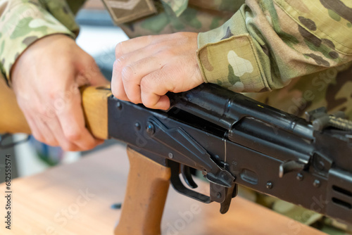 Soldier assembling old AK-47 Kalashnikov assault rifle