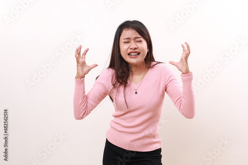 Stressed frustrated depressed young asian girl standing against white background