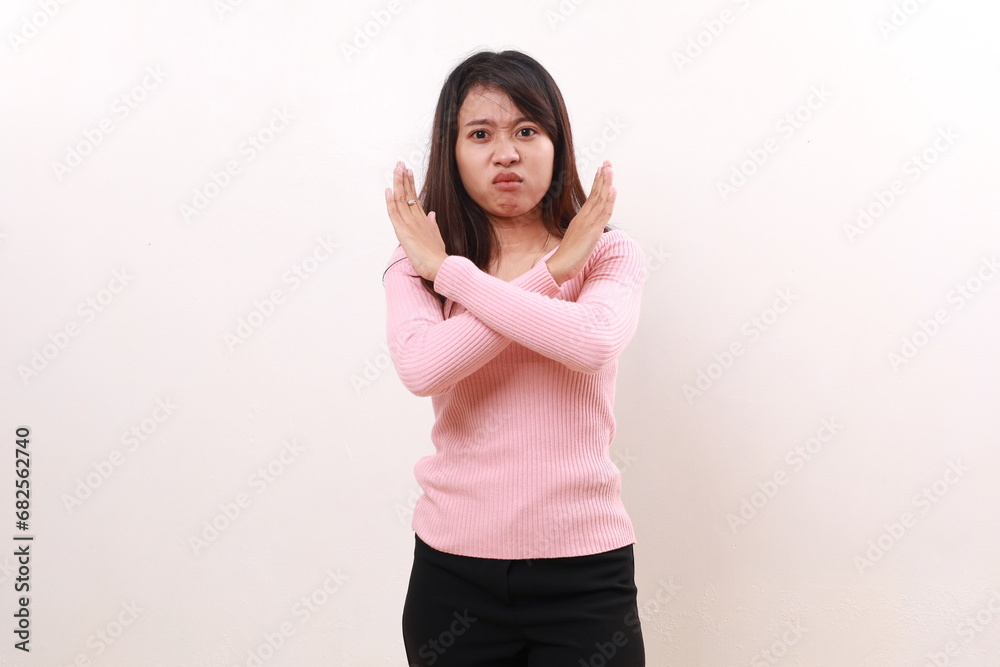 Angry young asian girl standing while crossing her hands. Rejection concept. Isolated on white Angry young asian girl standing while crossing her hands. Rejection concept. Isolated on white