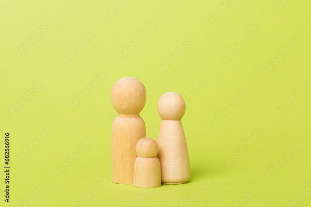 Wooden family figures on color background Wooden family figures on color background