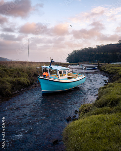 Boat moored in a river at sunset