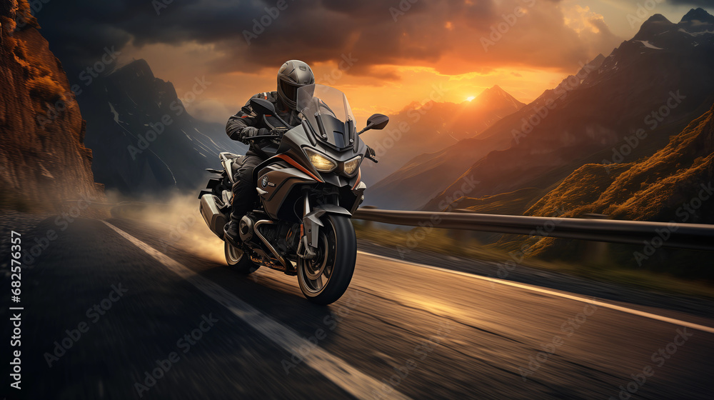A motorcycle / motorcyclist riding down a scenic curvy road - obrazy, fototapety, plakaty 