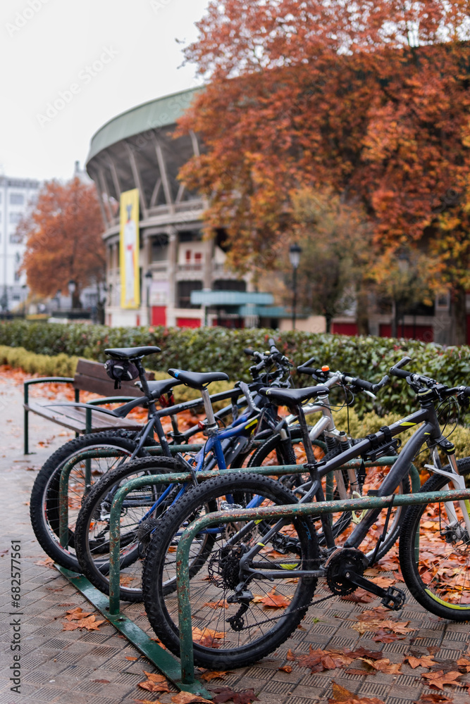 Foggy day, bikes parked near Pamplona's bullring in autumn ambiance.