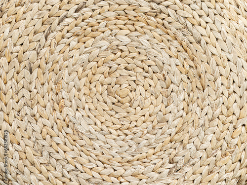 Background is made of woven straw. Circular pattern.