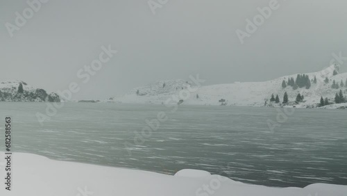 Windy snowy weather on Truebsee lake in Engelberg, Switzerland. Swiss Alps photo