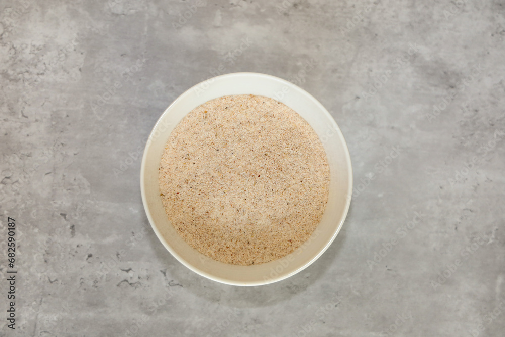 Top view of psyllium husks flakes in a white bowl. Top view of psyllium husks flakes in a white bowl.