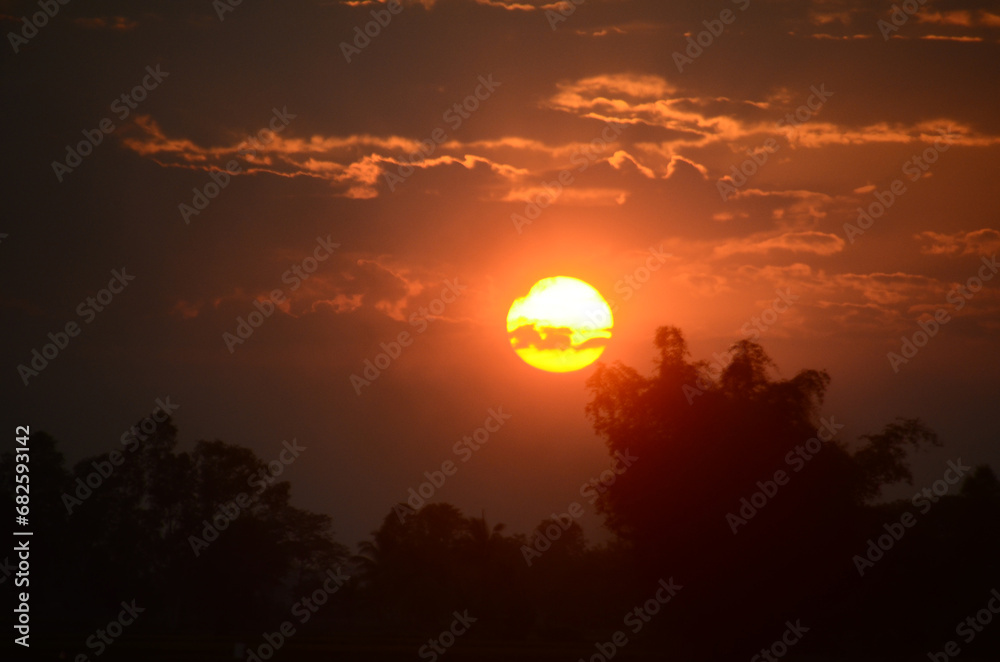 Scenic view dramatic beautiful sunset sky. Natural Sunset Sunrise on meadow silhouette shadow dark land. Vibrant dramatic sky on sunset, dawn, sunrise in Countryside. Landscape Colorful Sky At Sunset