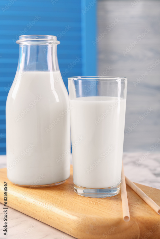 Glassware with tasty milk and straws on table Glassware with tasty milk and straws on table