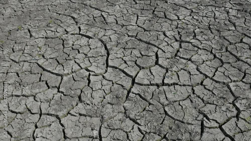 Cracked mud dried ground in lake bed. Global warming concept. Dry cracks in land, serious water shortages. Drought Cracked mud dried ground in lake bed. Global warming concept. Dry cracks in land, serious water shortages. Drought