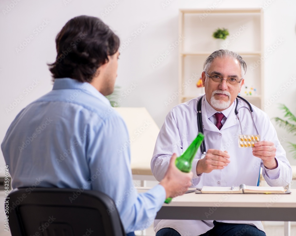 Young male alcoholic visiting old doctor