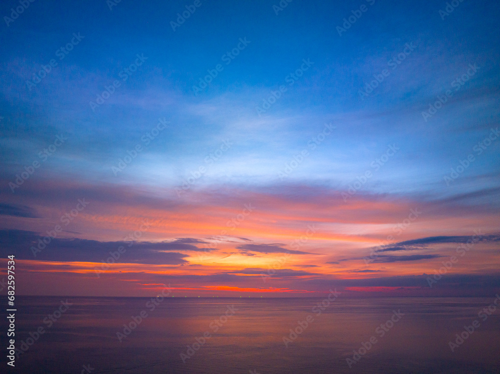 aerial view colorful reflection of stunning sunset..beautiful scene with the sun painting the sky above waves .breaking gently on a sandy.Gradient sweet color. abstract nature background