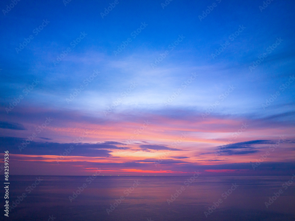 aerial view colorful reflection of stunning sunset..beautiful scene with the sun painting the sky above waves .breaking gently on a sandy.Gradient sweet color. abstract nature background