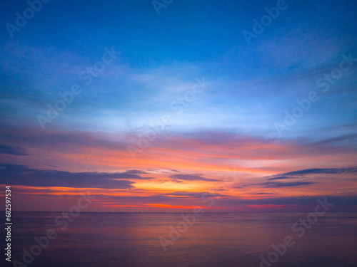 aerial view colorful reflection of stunning sunset..beautiful scene with the sun painting the sky above waves .breaking gently on a sandy.Gradient sweet color. abstract nature background © Narong Niemhom