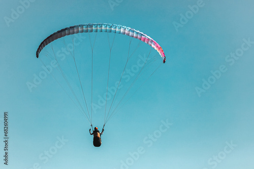 Paraglider in the sky. The sportsman flying on a paraglider.