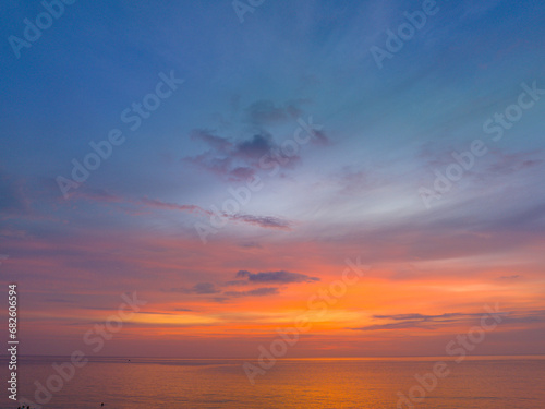 Aerial view colorful reflection of stunning sunset..beautiful scene with the sun painting the sky above waves .breaking gently on a sandy.Gradient sweet color. abstract nature background. © Narong Niemhom