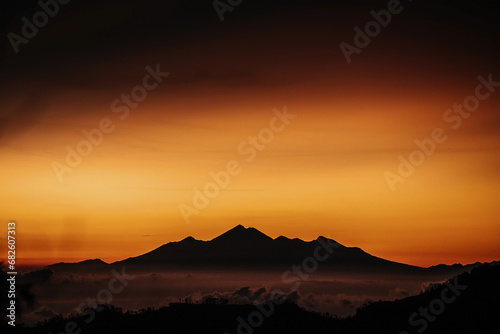 View of mountain with fog at sunset