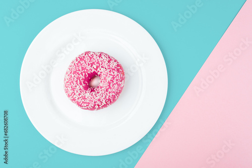 Pink donut on color background  flat lay  top view